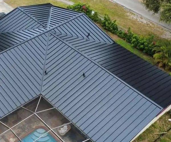 New metal roof over a home with a screened pool