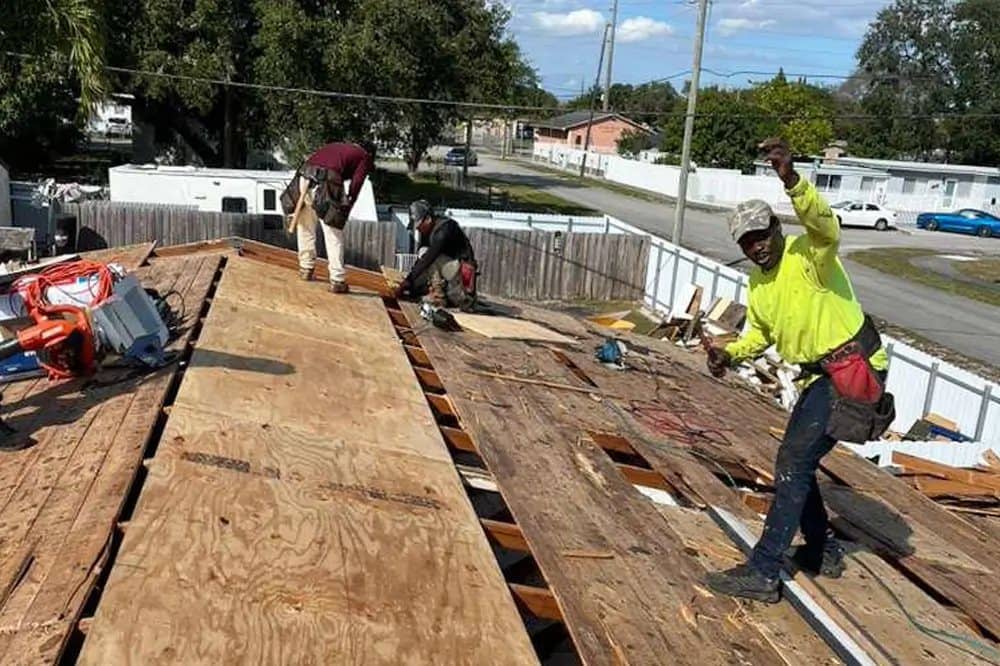 Crew replacing damaged plywood roof decking