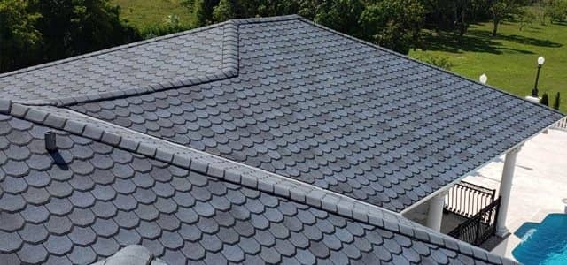 Dark shingle roof over a home with a pool