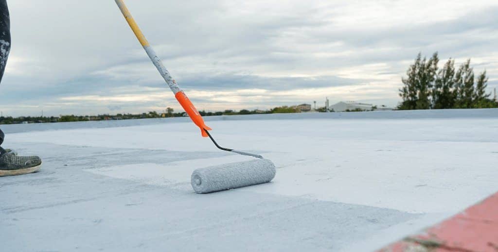 Silicone roof coating applied with a roller