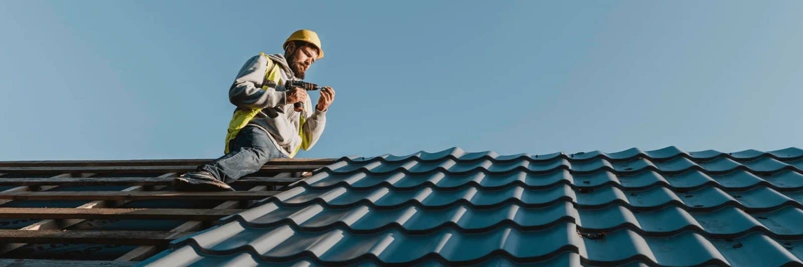 Roofer checking a tile roof for problems