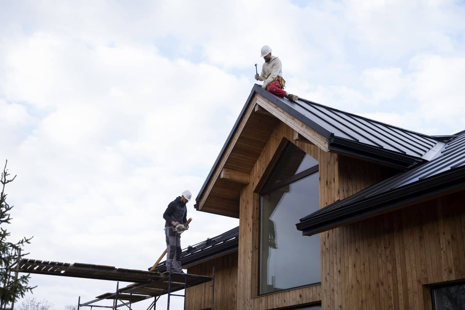 Roofers working on the roof of a house