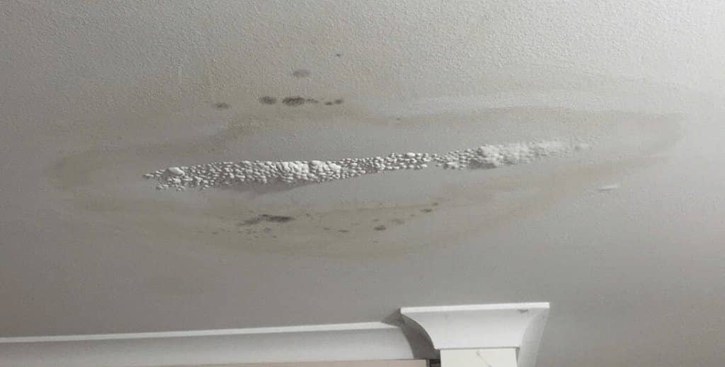 Water stain on a ceiling from a small roof leak