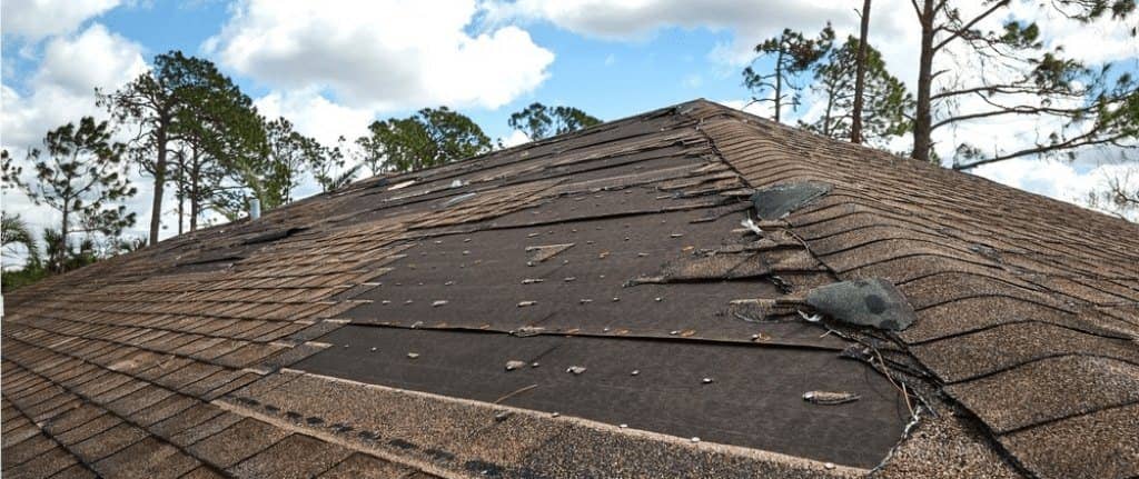Shingle roof with storm damage and missing shingles